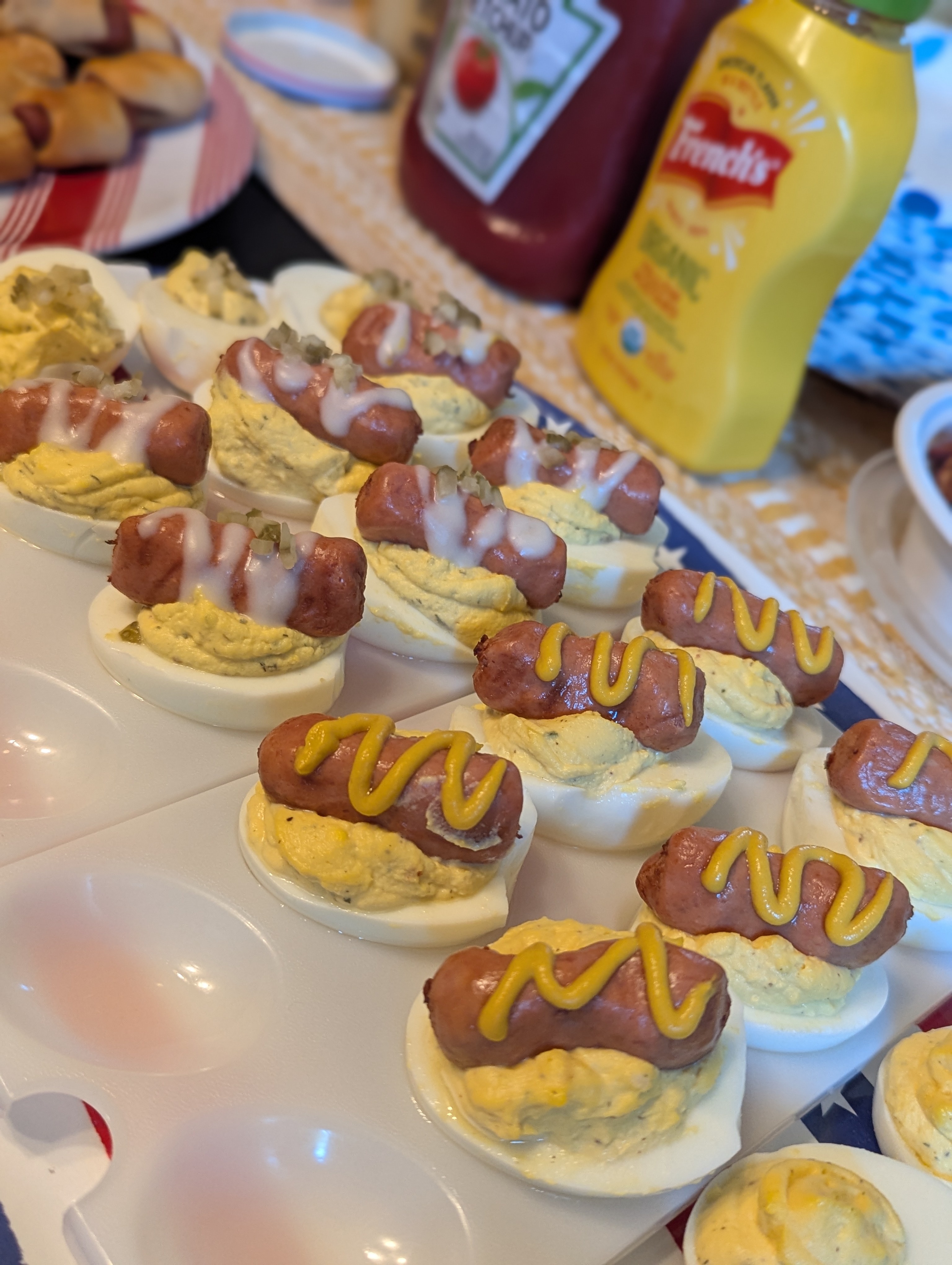 A dozen or so deviled eggs with weenies on top, dressed with a drizzle of either garlic aioli or mustard. We called them "Deviled Dogs."